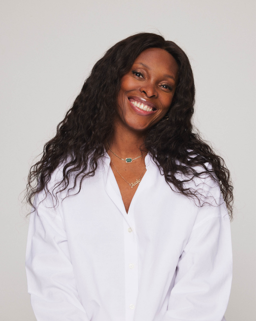 The Steam Bar Founder Judy Koloko smiling into camera 