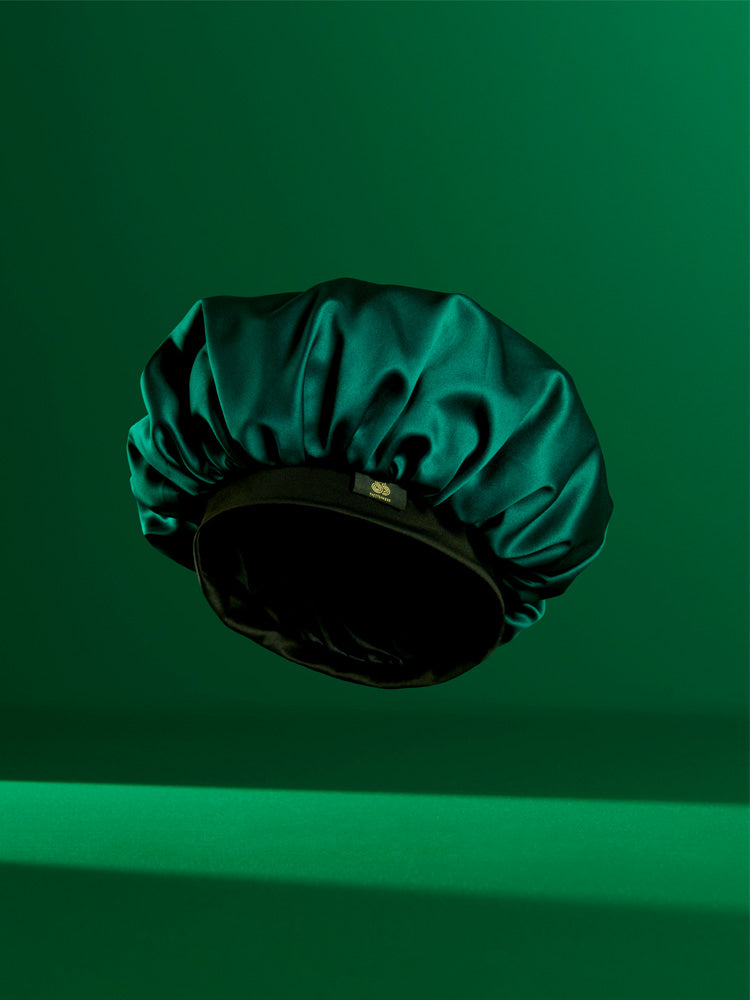 The Steam Bar's Satin Bonnet against a green background